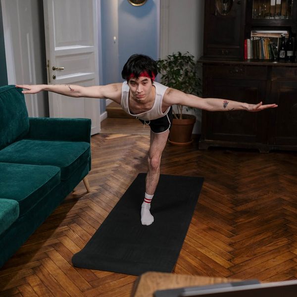 Man holding a challenging yoga pose, showing strength and focus.